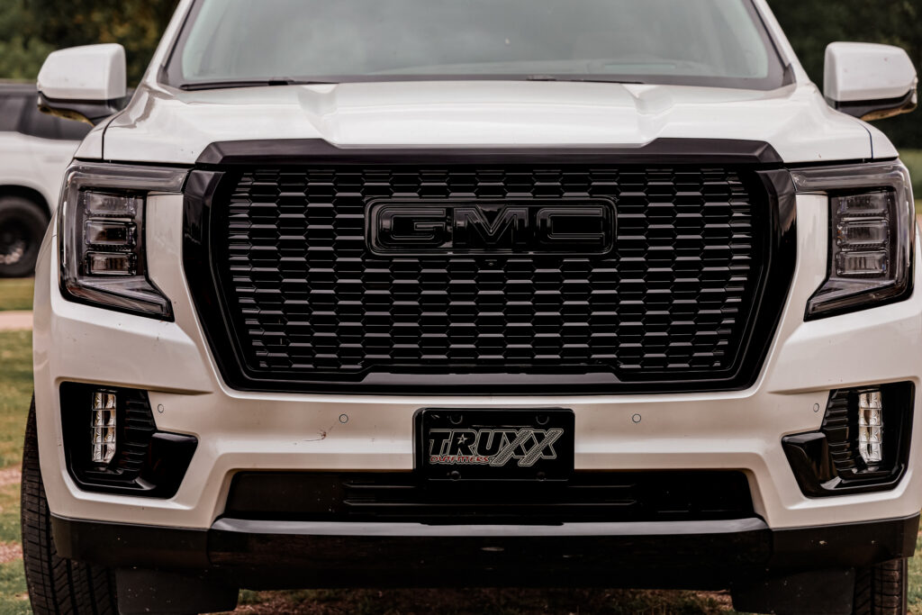 tinted head lights and front grille of 2024 GMC Yukon Denali