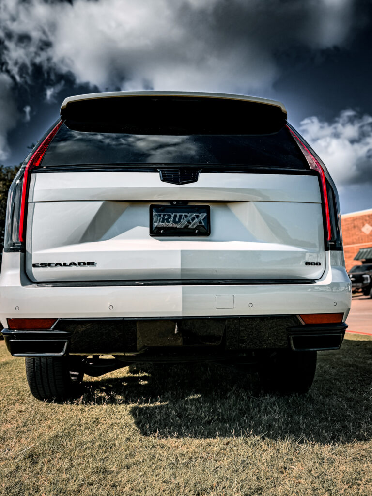 Rear view of the 2024 Cadillac Escalade with blacked-out emblems and lettering, illustrating the comprehensive chrome delete by TRUXX Outfitters