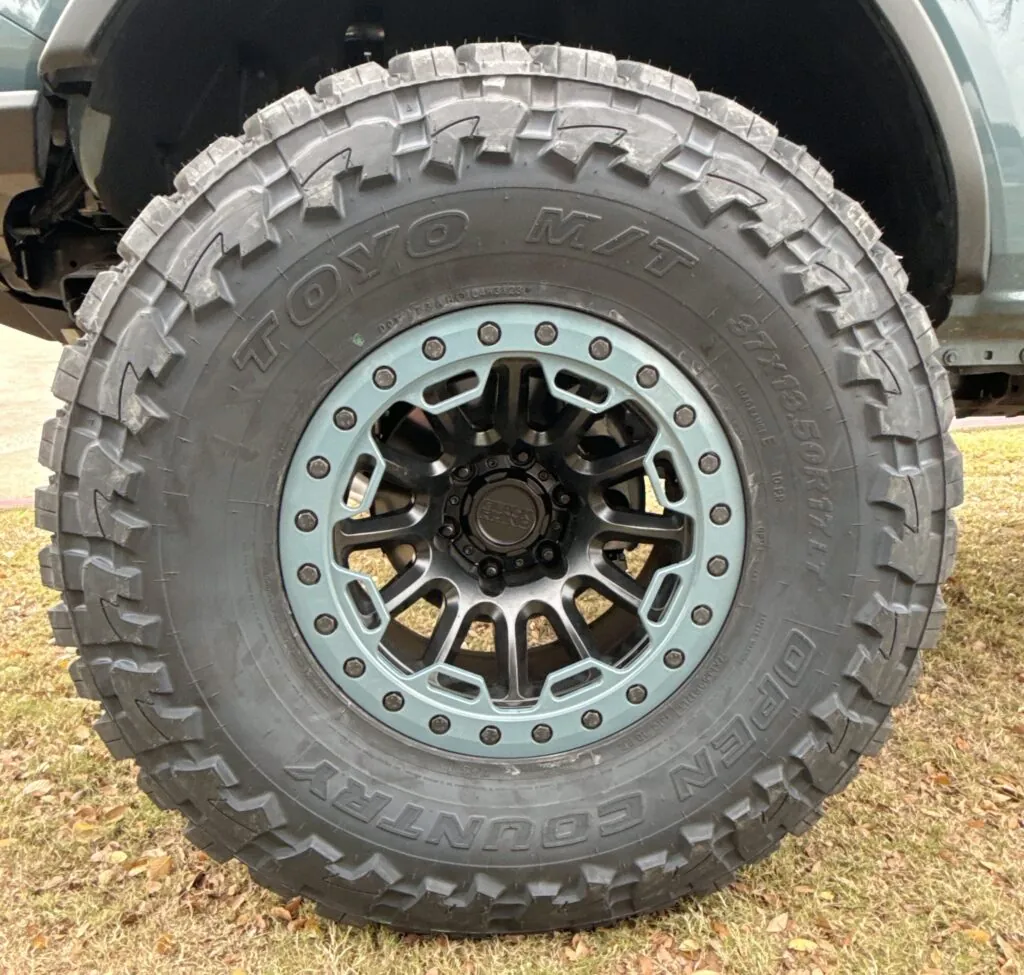36/13.50/17 Toyo Open Country MT Tires with Black Rhino Bead lock Simulation 17” Wheels with custom painted ring