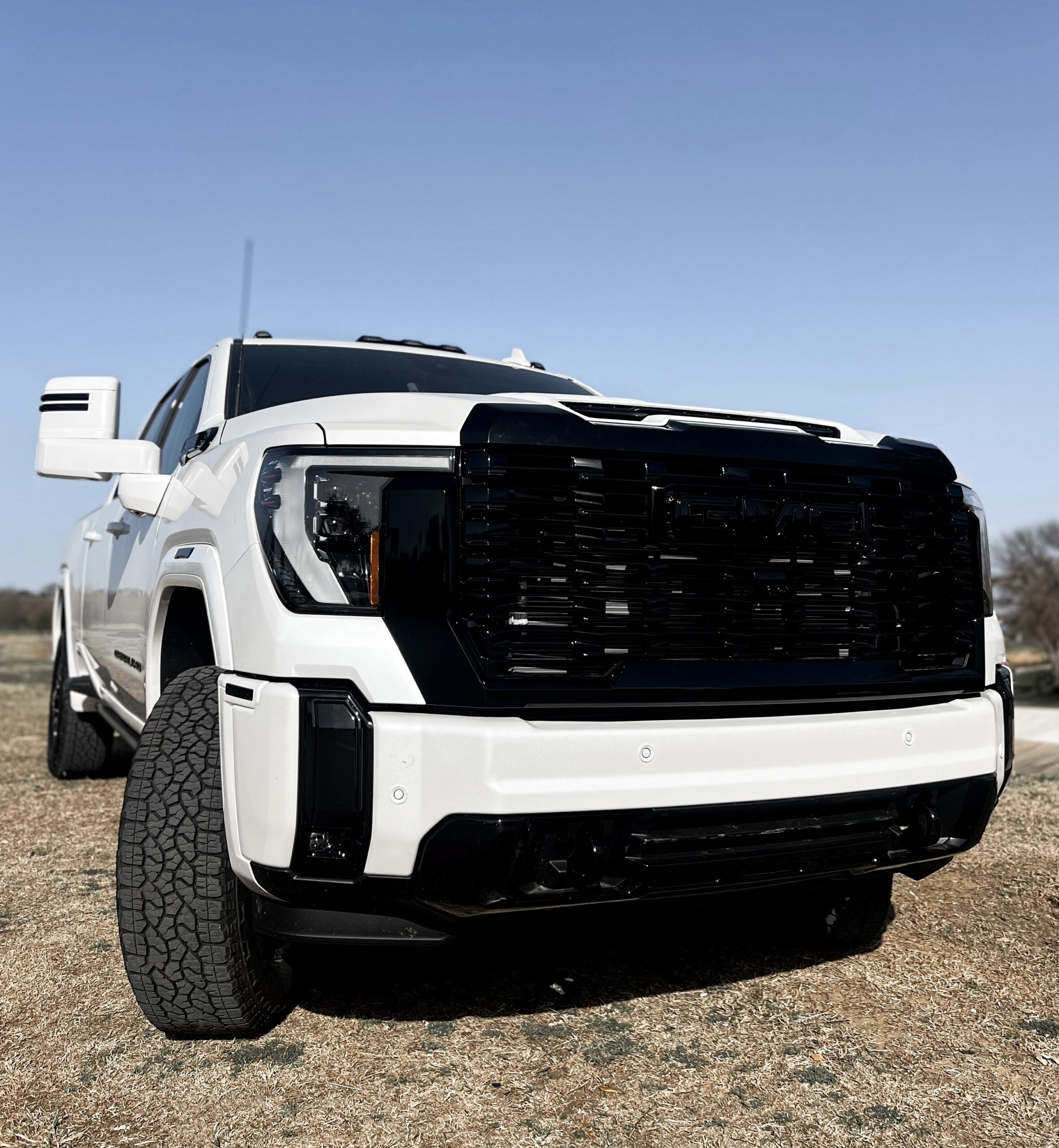 Upgraded GMC Sierra HD Denali with custom lifts, wheels, performance mods, and Truxx Airwrap color transformations